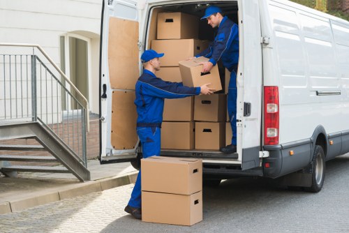 Professional movers transporting furniture in Balham street