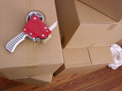 Packed office equipment and labelled boxes prepared for relocation in Balham